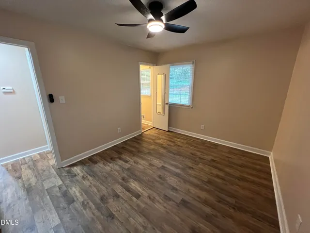 wooden floor in an empty room with a window