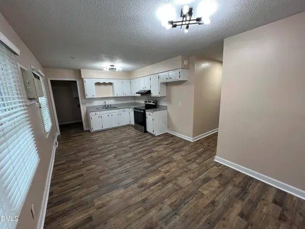 a kitchen with a refrigerator and a sink