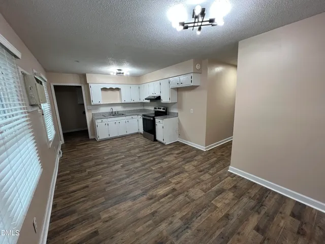a kitchen with a refrigerator and a sink