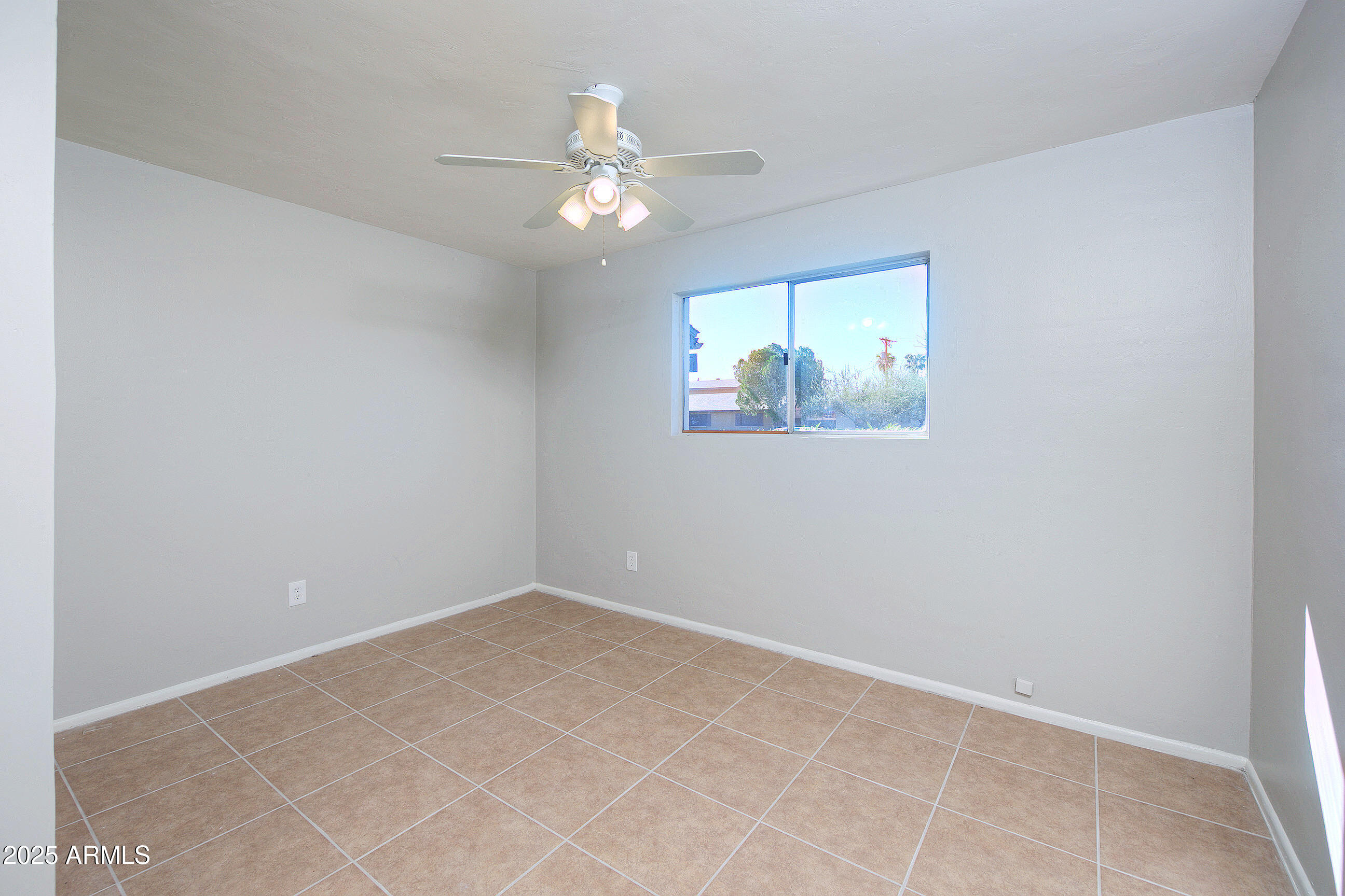 1206 West 9th Street Tempe, AZ 85281 - Photo 13 of 23 an empty room with wooden floor and chandelier fan