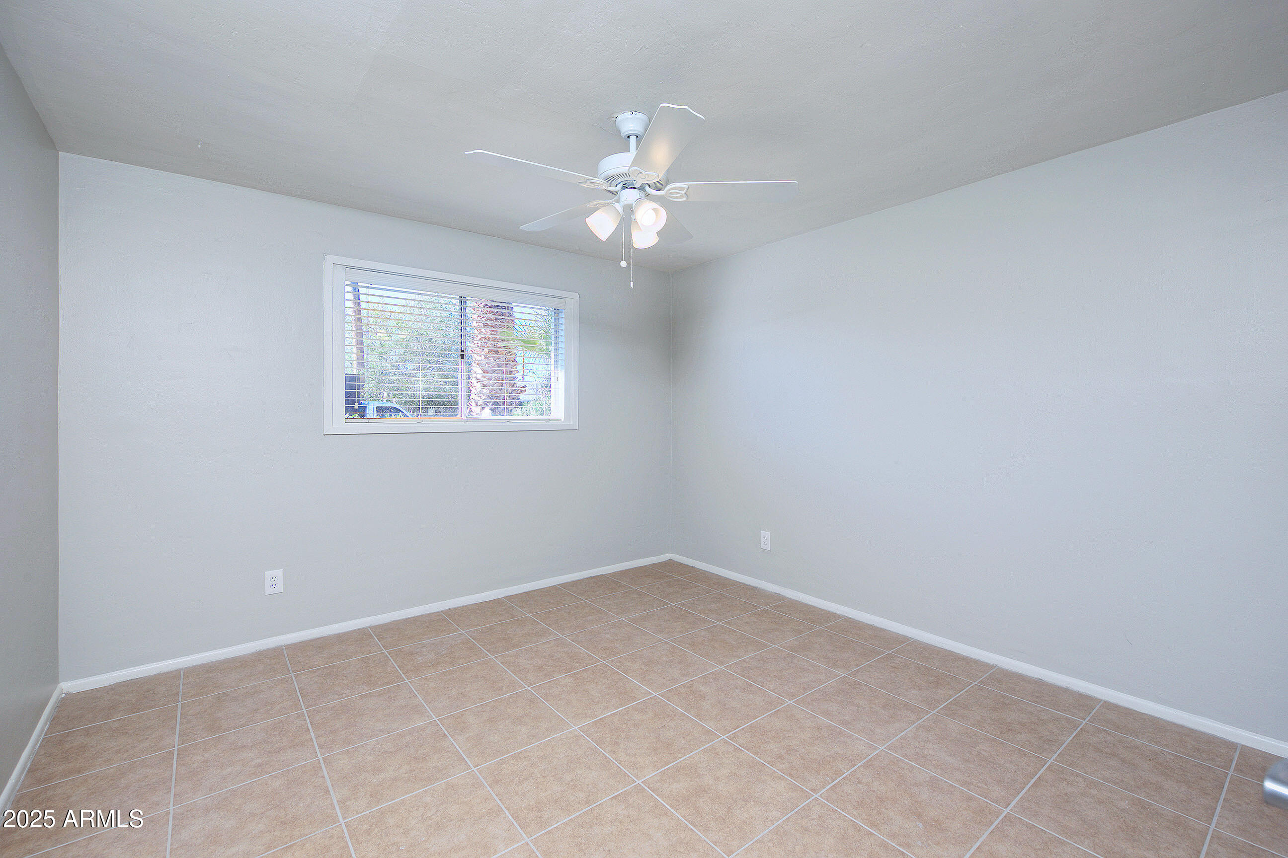 1206 West 9th Street Tempe, AZ 85281 - Photo 15 of 23 an empty room with a window and a fan