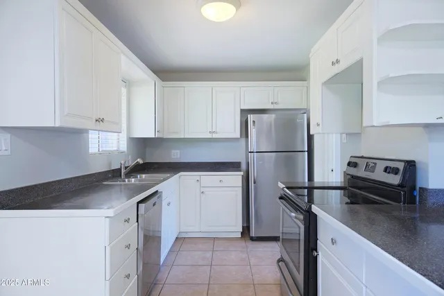 a kitchen with a refrigerator and a sink