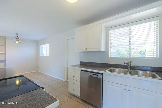 a kitchen with a sink cabinets and window