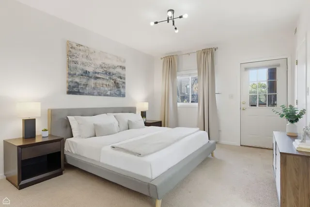 a bedroom with a bed and a potted plant