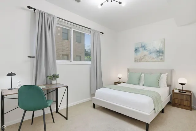 a bedroom with a bed and a chair