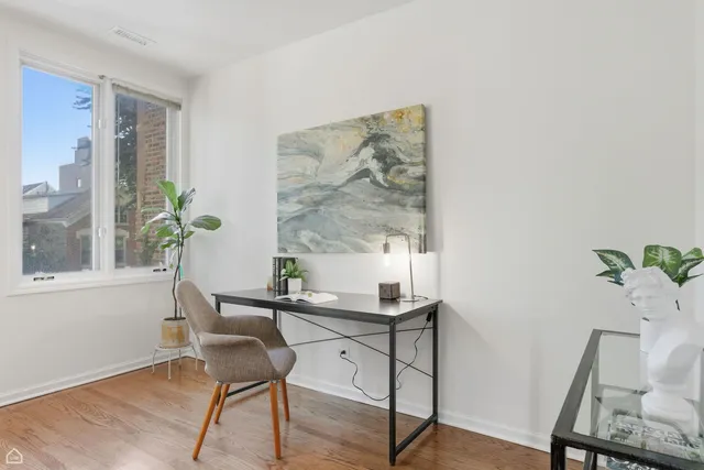 a view of a workspace with furniture and a potted plant