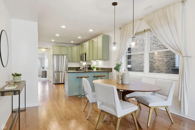 a dining room with furniture and a chandelier