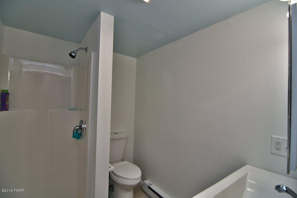 3145 Northgate Road Lake Ariel, PA 18436 - Photo 26 of 78 a white toilet sitting next to a bathroom sink
