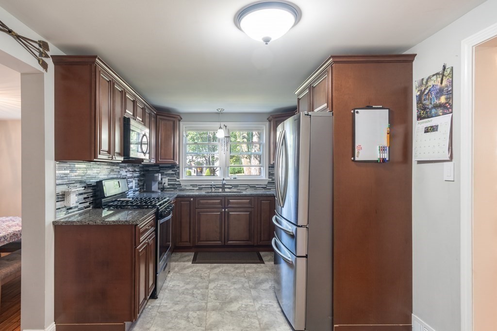 55 Lyman Street West Springfield, MA 01089 - Photo 6 of 24 a kitchen with stainless steel appliances granite countertop a refrigerator sink and stove