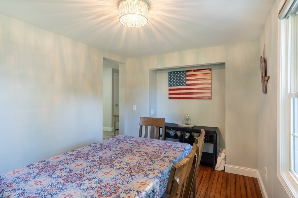 55 Lyman Street West Springfield, MA 01089 - Photo 10 of 24 a bedroom with a bed and a chandelier