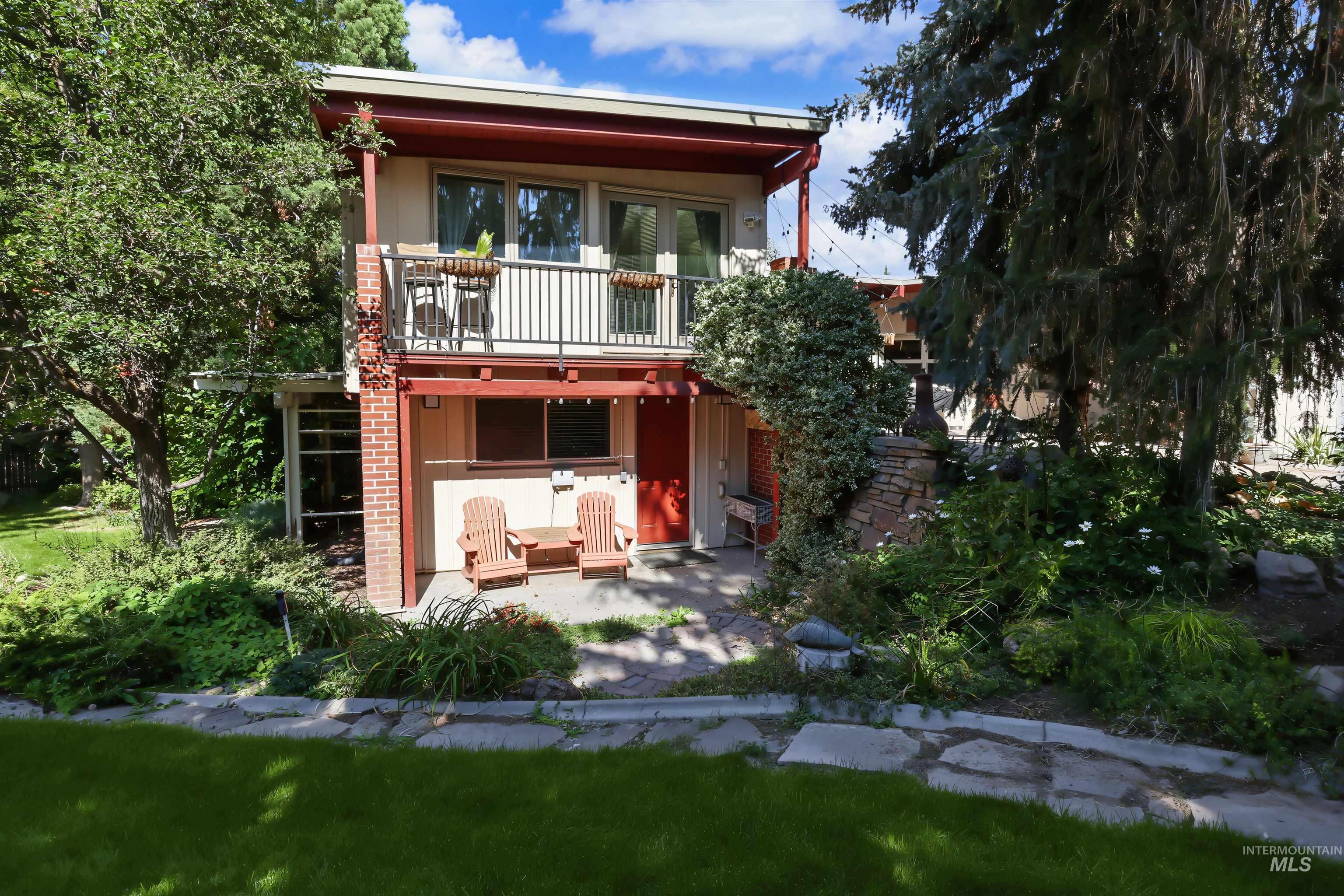 508 East Elm Avenue Parma, ID 83660 - Photo 43 of 50 Two-story exterior with a second-level balcony, ground-level patio, and brick accents