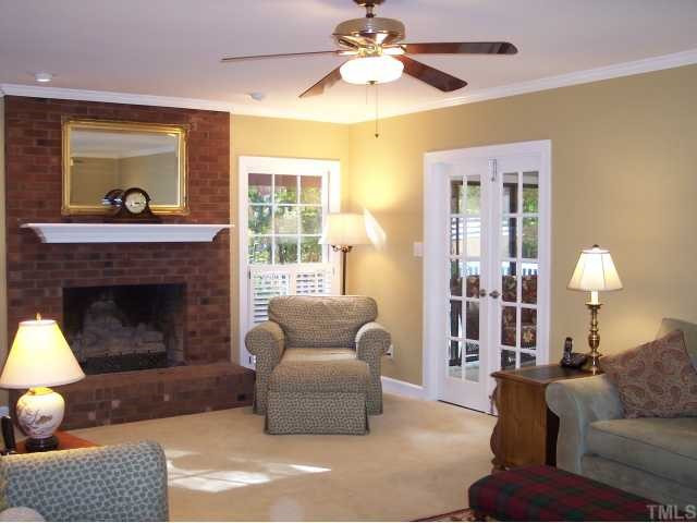 11805 Old Creedmoor Road Raleigh, NC 27613 - Photo 6 of 12 Partial View of the Very Large Family Room. The 23.5' X 15.5' Room Features an Oversize Gas Log Fireplace, Accent Lighting, Crown Moldings, a Lighted Paddle Fan, Upgraded Carpet & Pad, and Built-In Stereo Cabinetry. French Doors Open to the Sun Room. Den/Family/Great Room