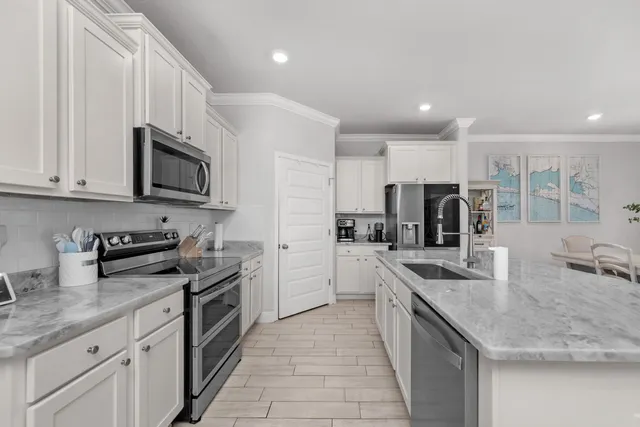 a kitchen with stainless steel appliances granite countertop a sink stove and refrigerator