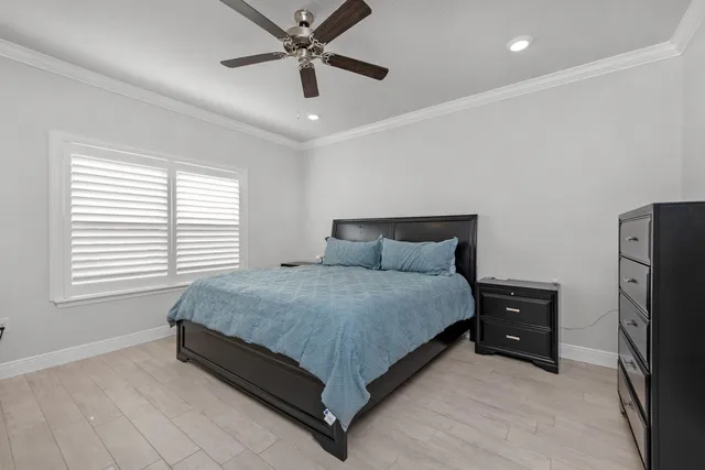 a bedroom with a bed and a ceiling fan