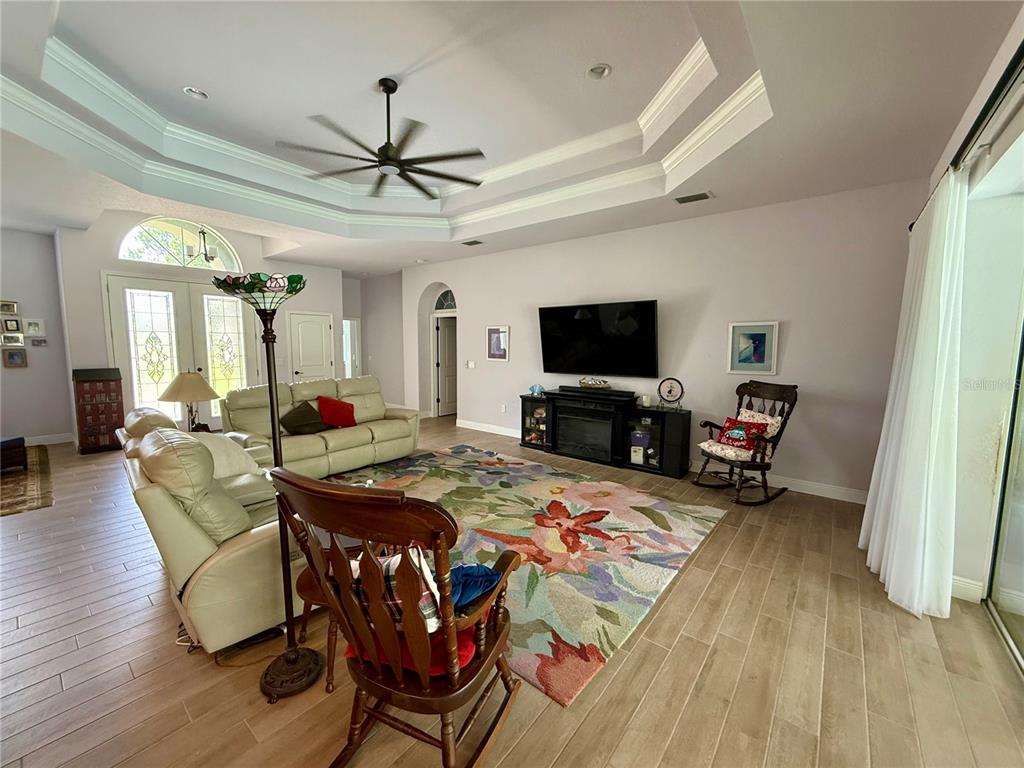 13110 Bamboo Street Spring Hill, FL 34609 - Photo 8 of 56 a view of a dining room with furniture a chandelier and wooden floor