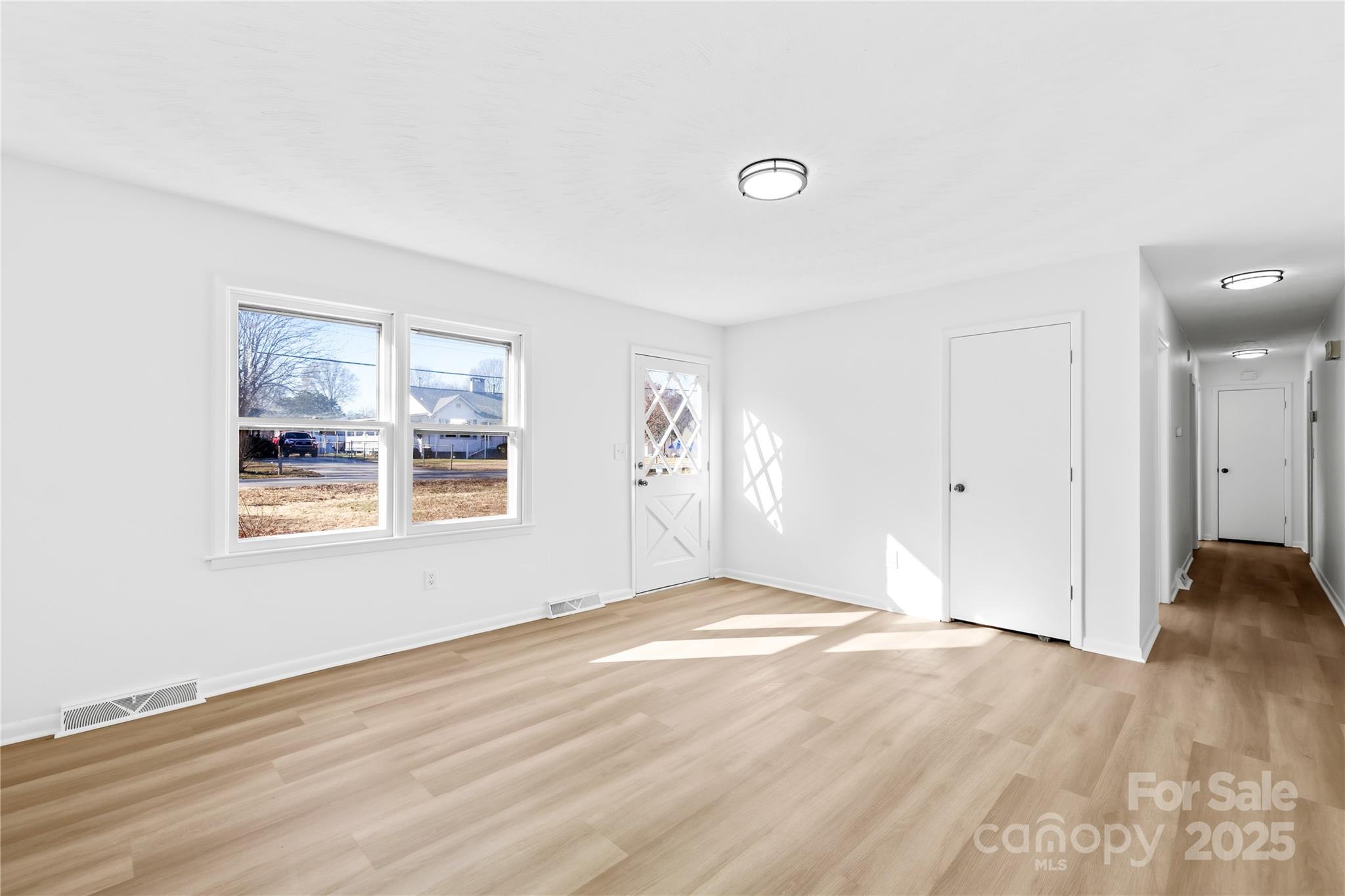 2405 Florida Avenue Kannapolis, NC 28083 - Photo 13 of 38 a view of an empty room with wooden floor and a window