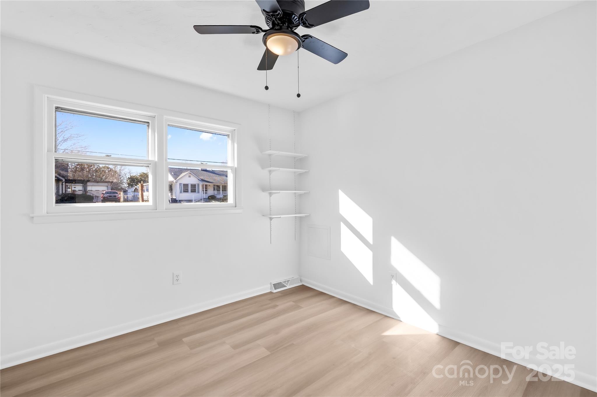 2405 Florida Avenue Kannapolis, NC 28083 - Photo 16 of 38 a view of empty room with wooden floor and fan