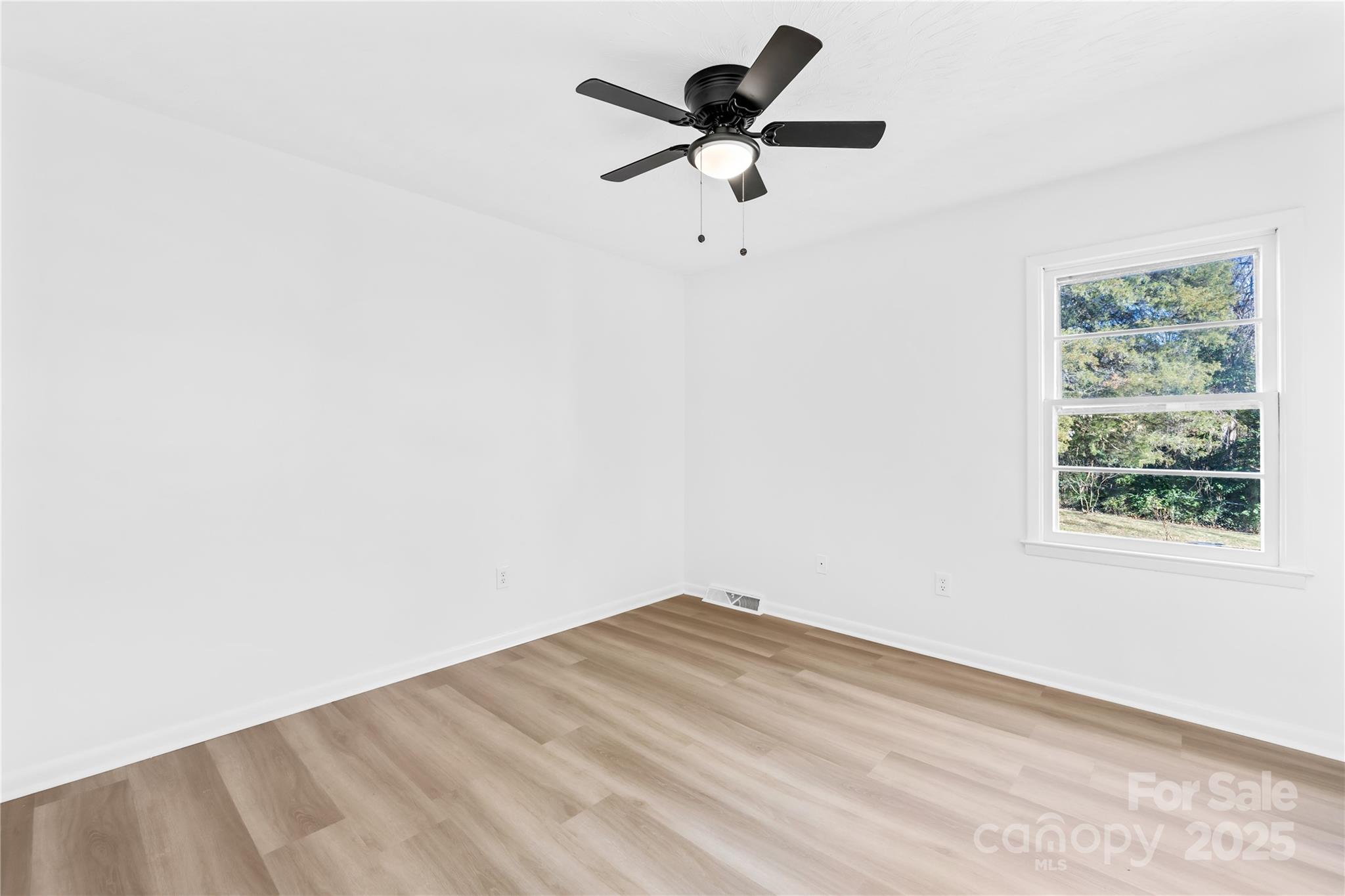 2405 Florida Avenue Kannapolis, NC 28083 - Photo 17 of 38 an empty room with a window and a fan