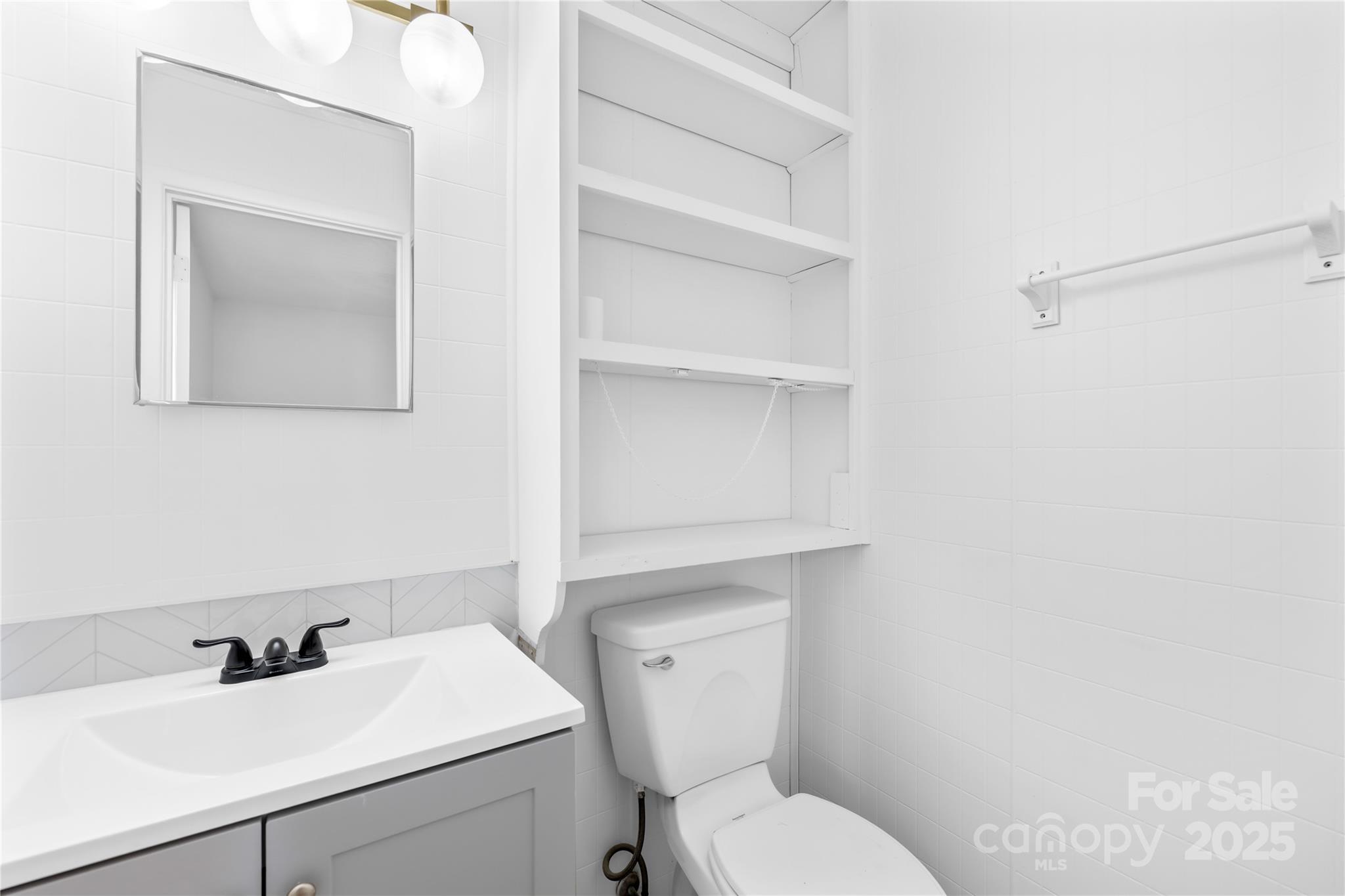 2405 Florida Avenue Kannapolis, NC 28083 - Photo 19 of 38 a bathroom with a toilet sink and mirror