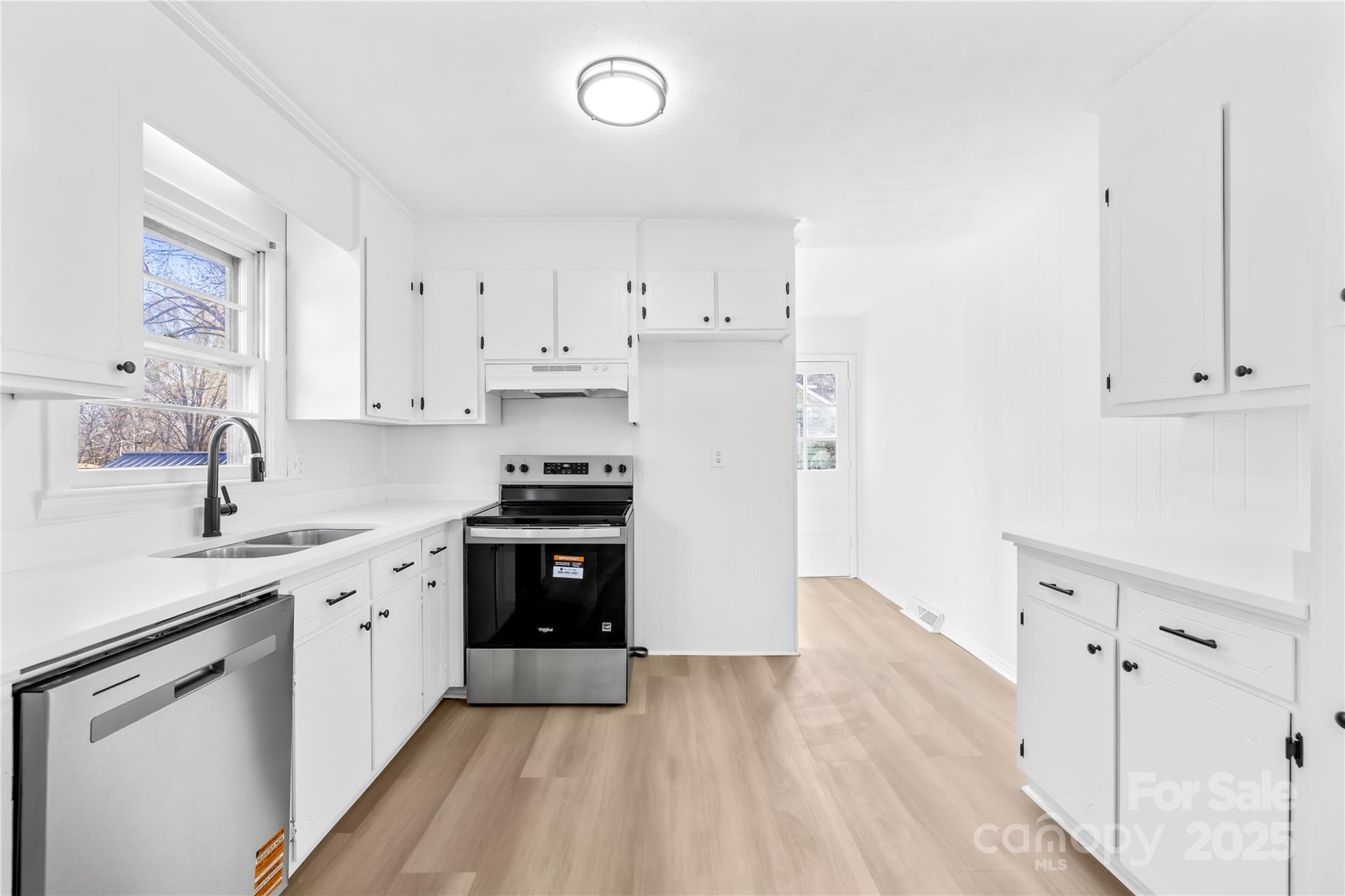 2405 Florida Avenue Kannapolis, NC 28083 - Photo 4 of 38 a kitchen with cabinets appliances a sink and a window