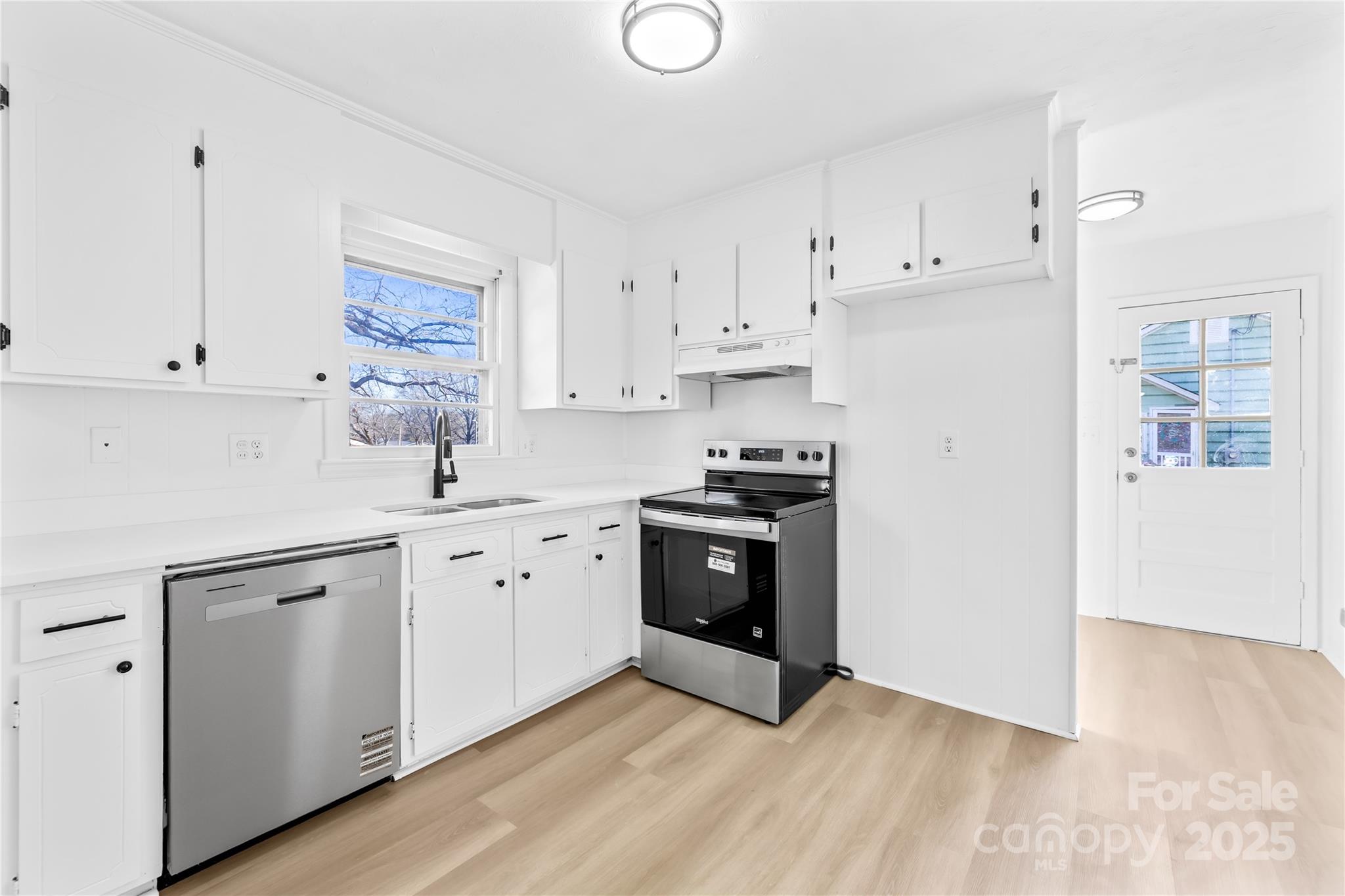 2405 Florida Avenue Kannapolis, NC 28083 - Photo 5 of 38 a kitchen with cabinets stainless steel appliances and a window
