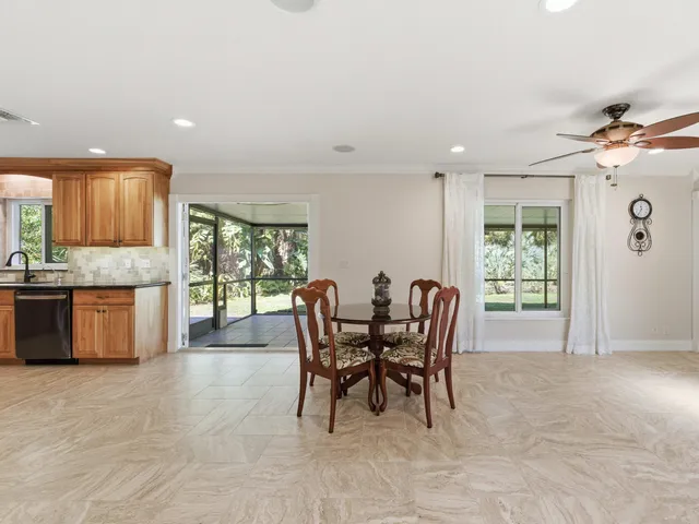 a view of a dining room with furniture and a large window
