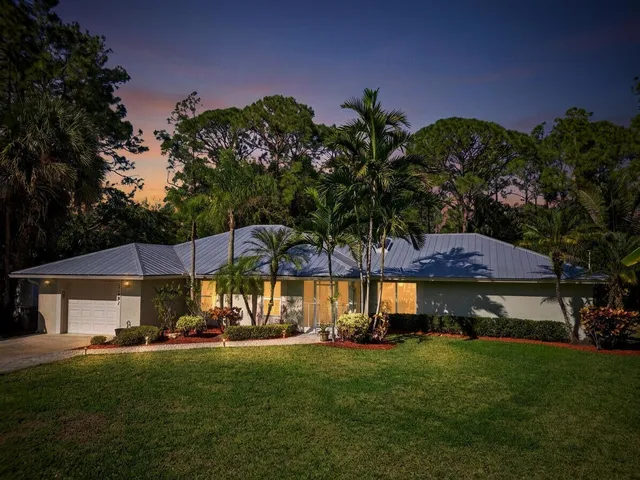a view of swimming pool and a yard in front of the house