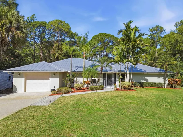 a patio with a table and chairs under an umbrella