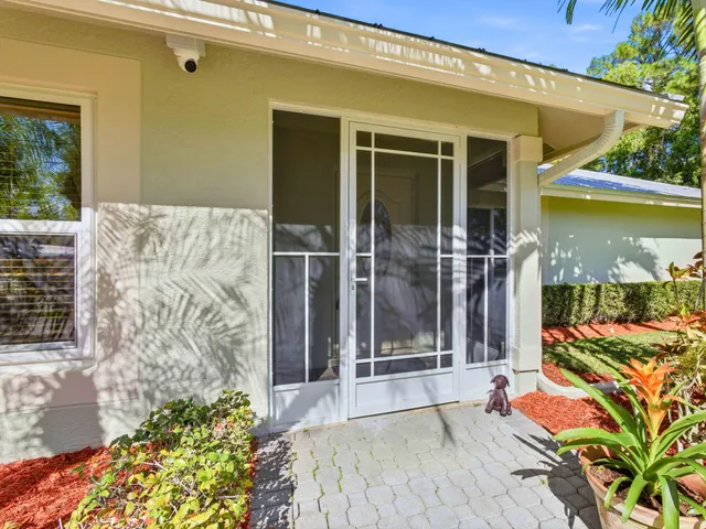 a balcony with couch and potted plants