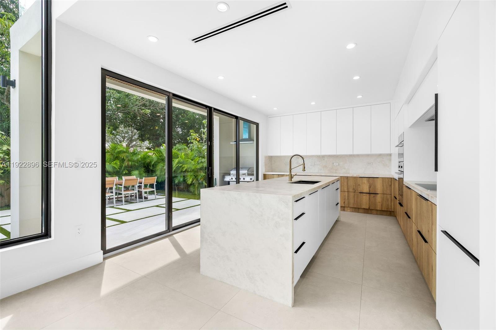 66 Northwest 50th Street Miami, FL 33127 - Photo 20 of 60 a large white kitchen with a large window