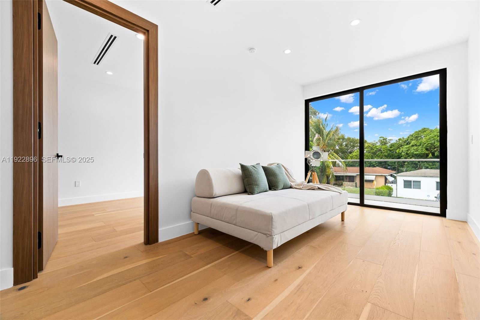 66 Northwest 50th Street Miami, FL 33127 - Photo 29 of 60 a living room with furniture and a large window