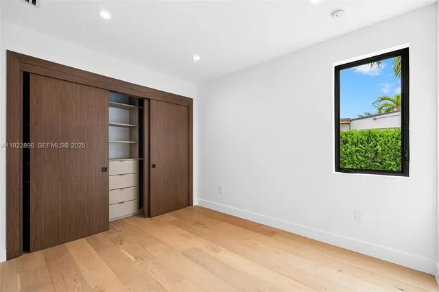a view of a red door with a bench in front of it