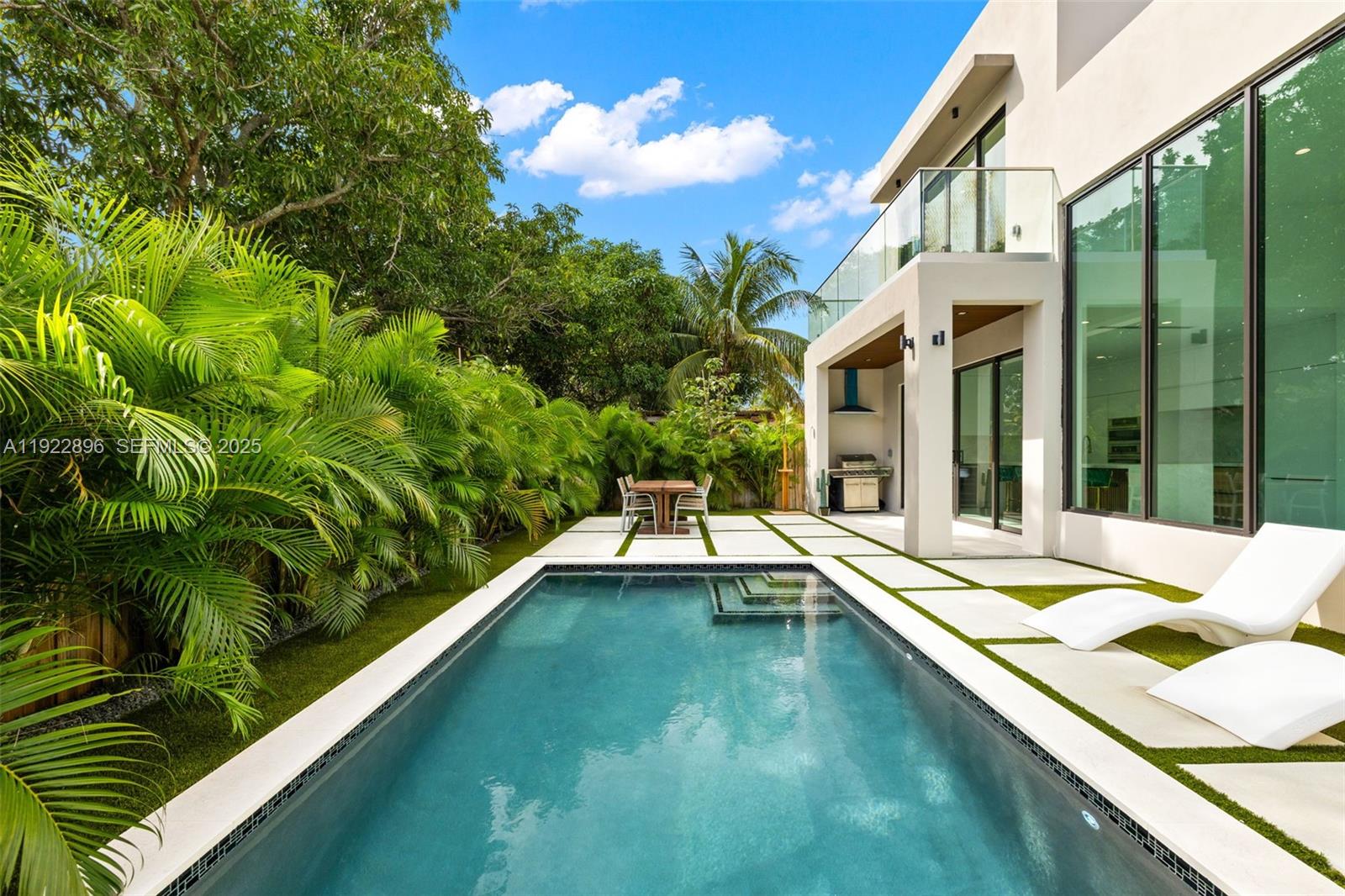 66 Northwest 50th Street Miami, FL 33127 - Photo 49 of 60 a view of a patio with swimming pool and porch
