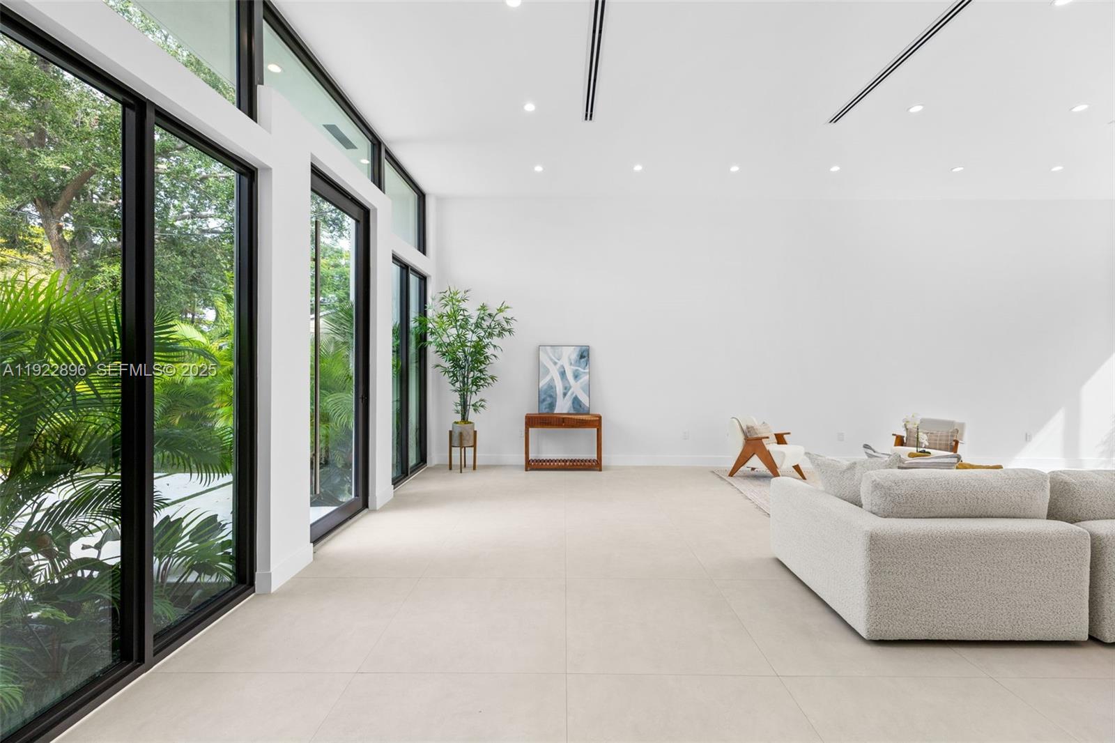 66 Northwest 50th Street Miami, FL 33127 - Photo 8 of 60 a living room with furniture and large windows
