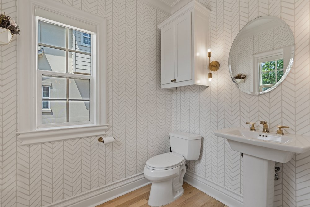 1609 Hartford Road, Unit A Austin, TX 78703 - Photo 21 of 39 A compact and stylish bathroom featuring a pedestal sink and bright window.