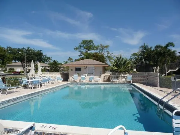a swimming pool with outdoor seating and yard
