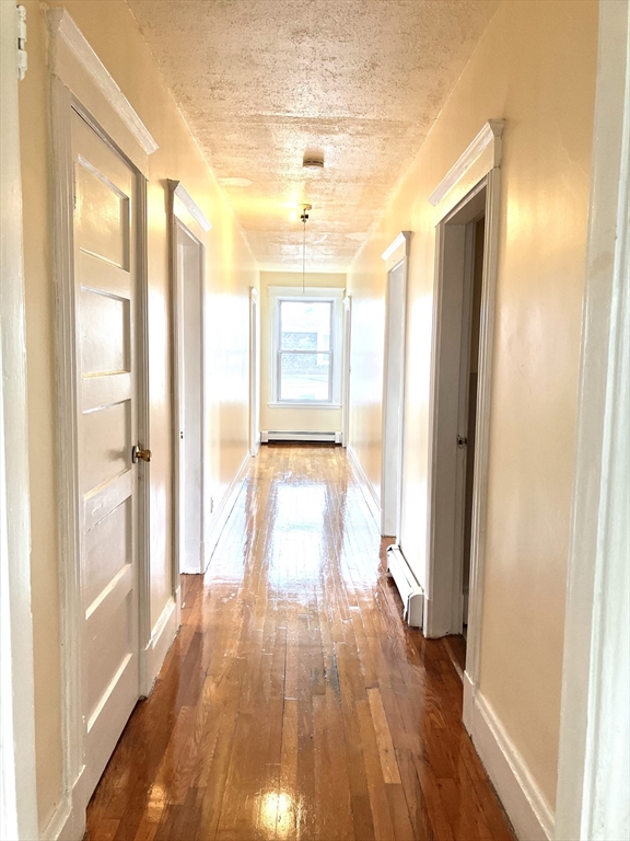 41 Brimblecom Street, Unit 3 Lynn, MA 01902 - Photo 2 of 16 a view of a room with wooden floor and a window