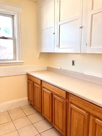 a kitchen with stainless steel appliances granite countertop a sink and a white cabinets