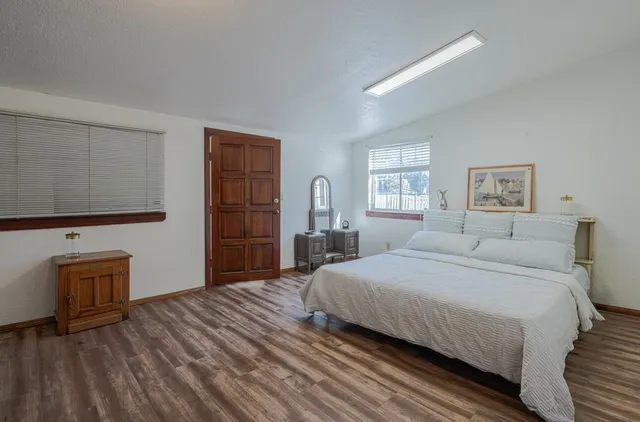 a spacious bedroom with a bed and a window