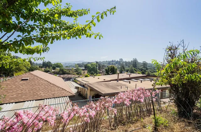 a view of a house with wooden fence