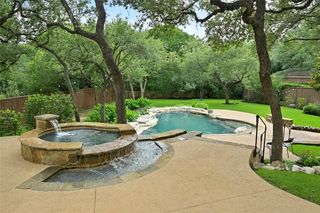 a swimming pool with outdoor seating and yard