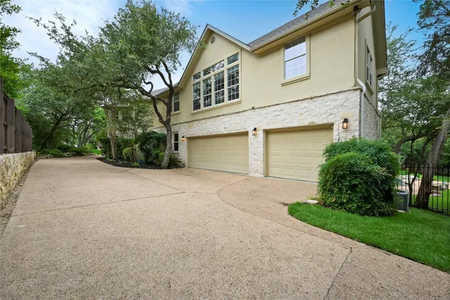 a front view of a house with a yard and a garage