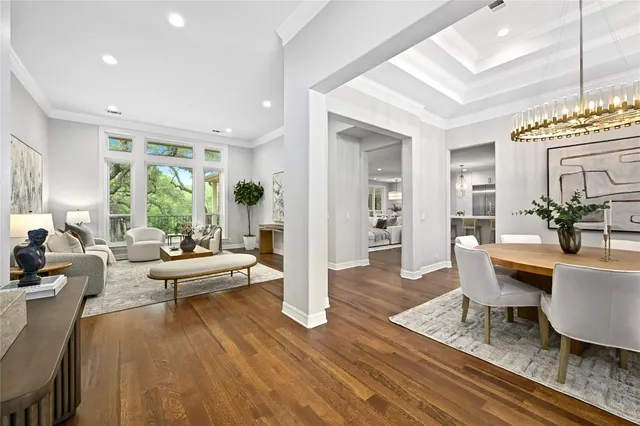 a living room with furniture dining table and a large window