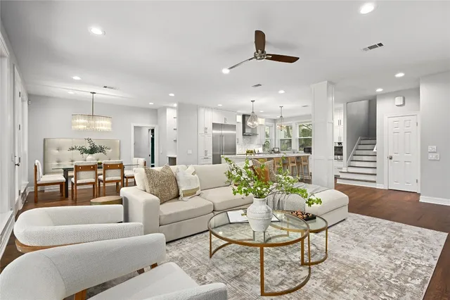 a living room with furniture and kitchen view