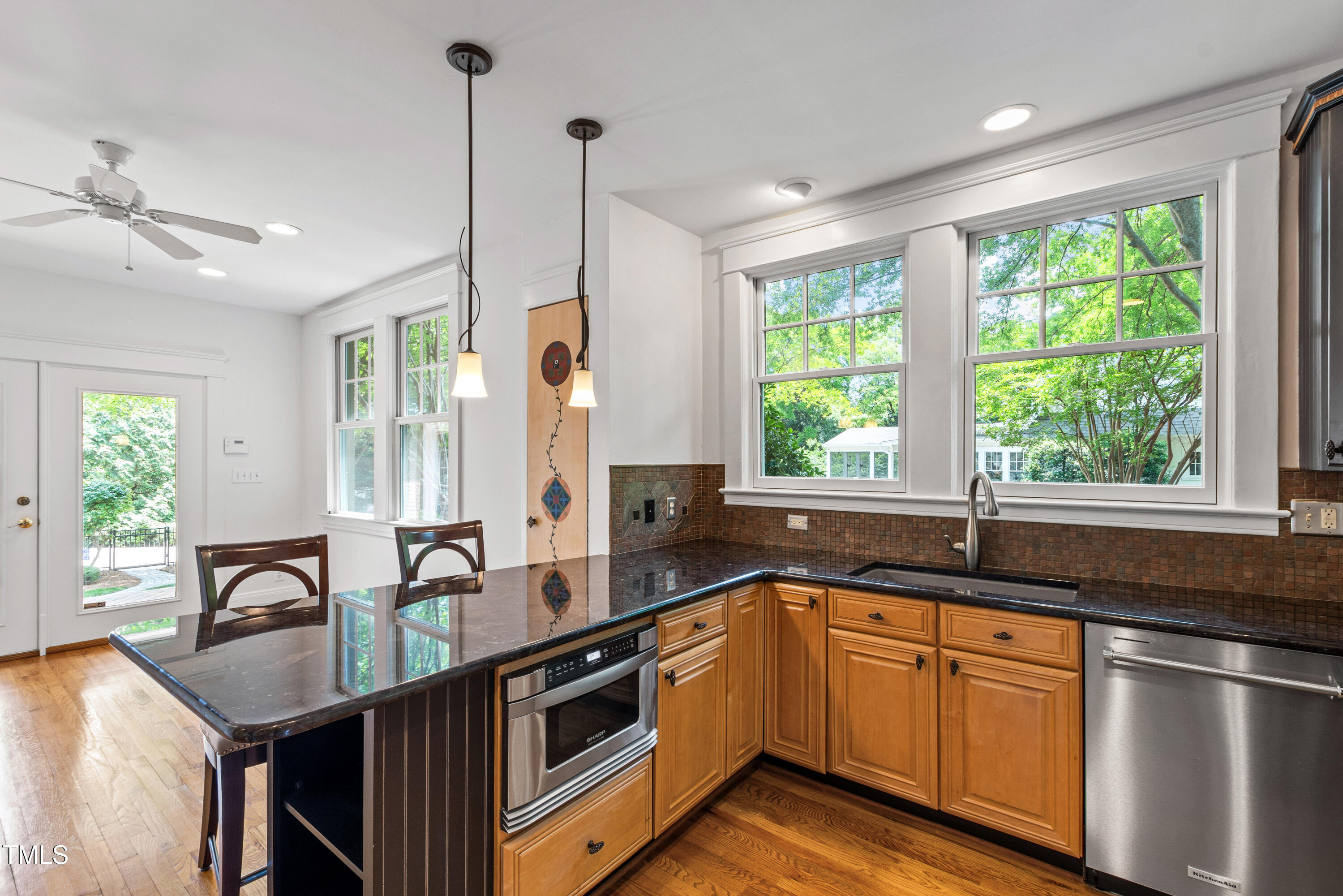 2202 St Marys Street Raleigh, NC 27608 - Photo 19 of 63 a kitchen that has a sink and a large window