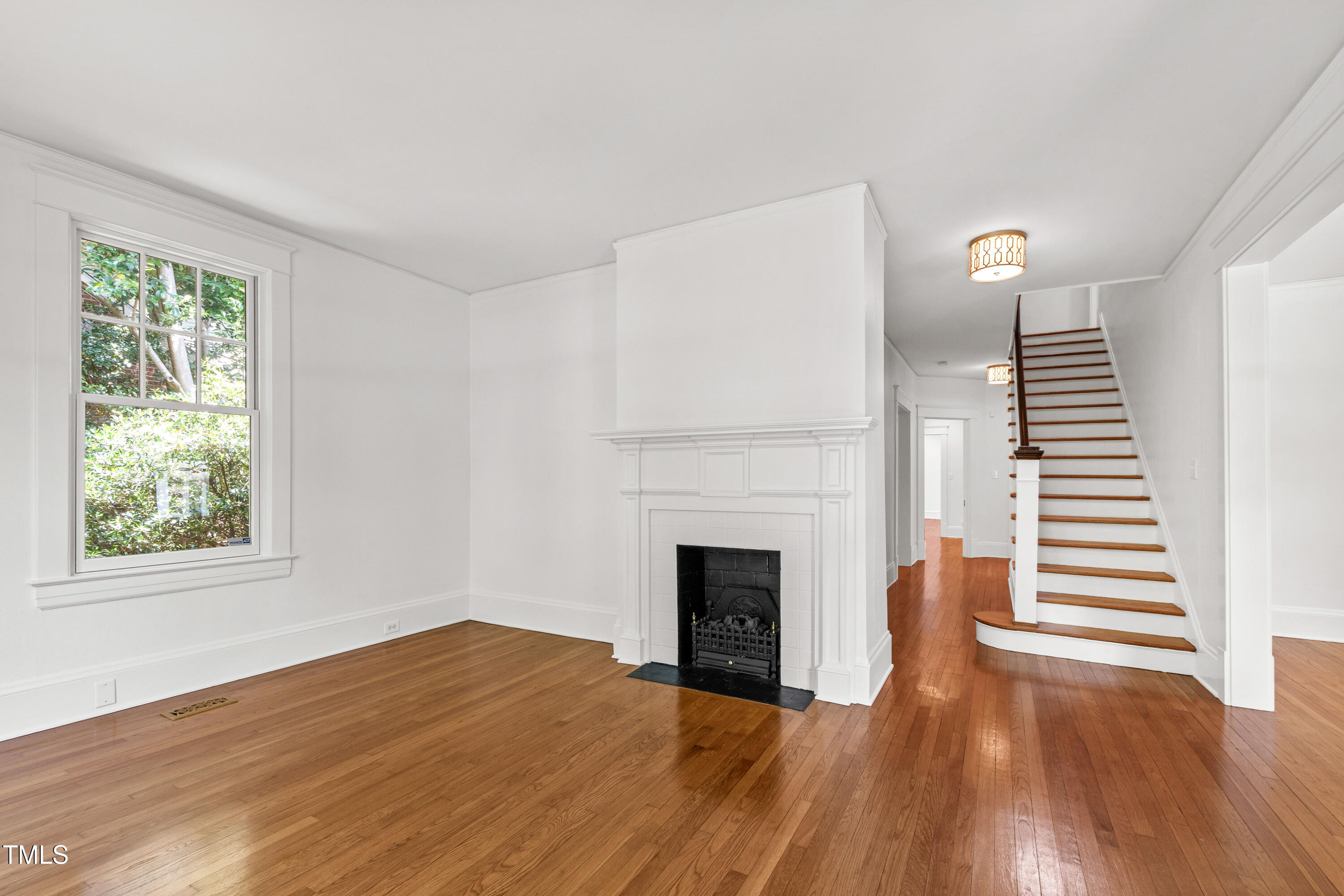 2202 St Marys Street Raleigh, NC 27608 - Photo 9 of 63 a view of a livingroom with wooden floor and a fireplace
