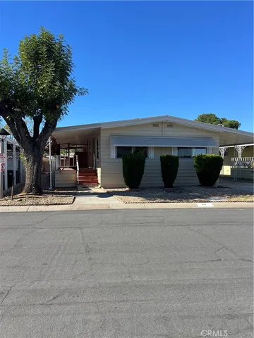 a side view of a house with cars parked