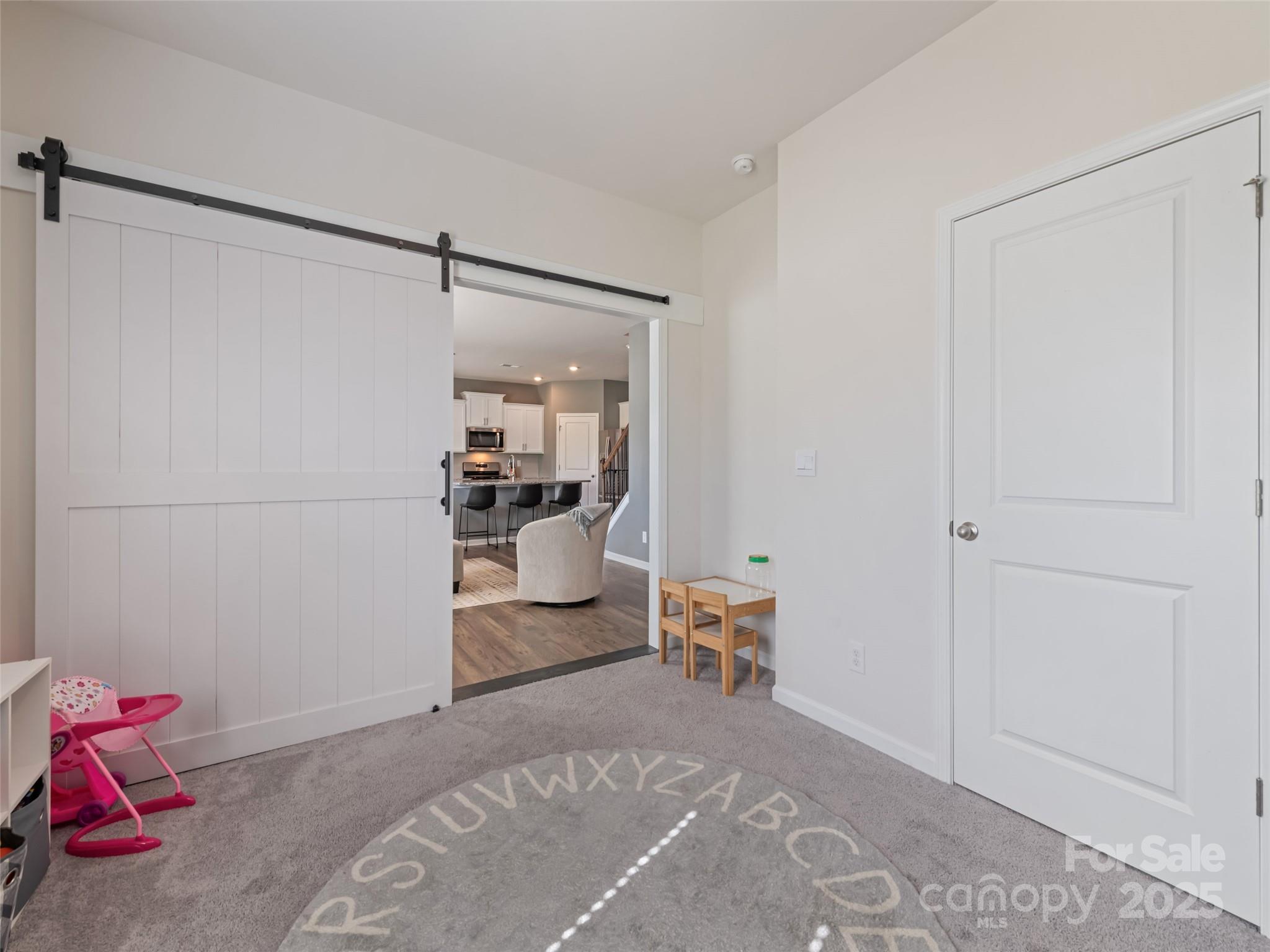 128 Wheatfield Road Fletcher, NC 28732 - Photo 15 of 44 a room with a baby crib furniture and a lamp