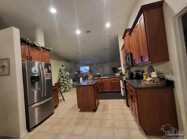 a kitchen with refrigerator and cabinets