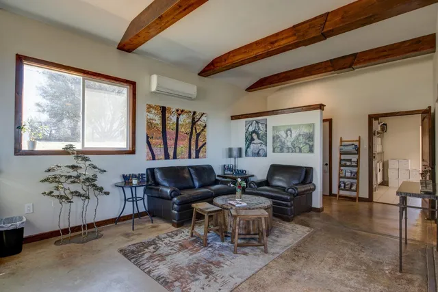 a view of a livingroom with furniture and a window
